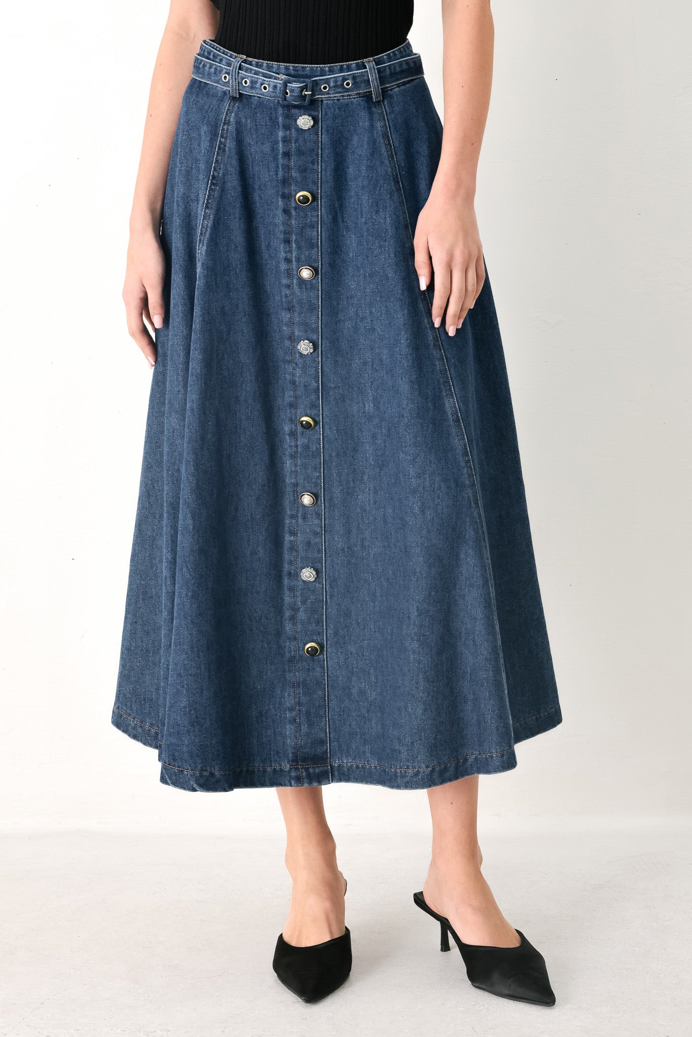 Woman wearing a blue denim circle midi skirt featuring self belt, button down detail and back zipper closure | FREEMARKET