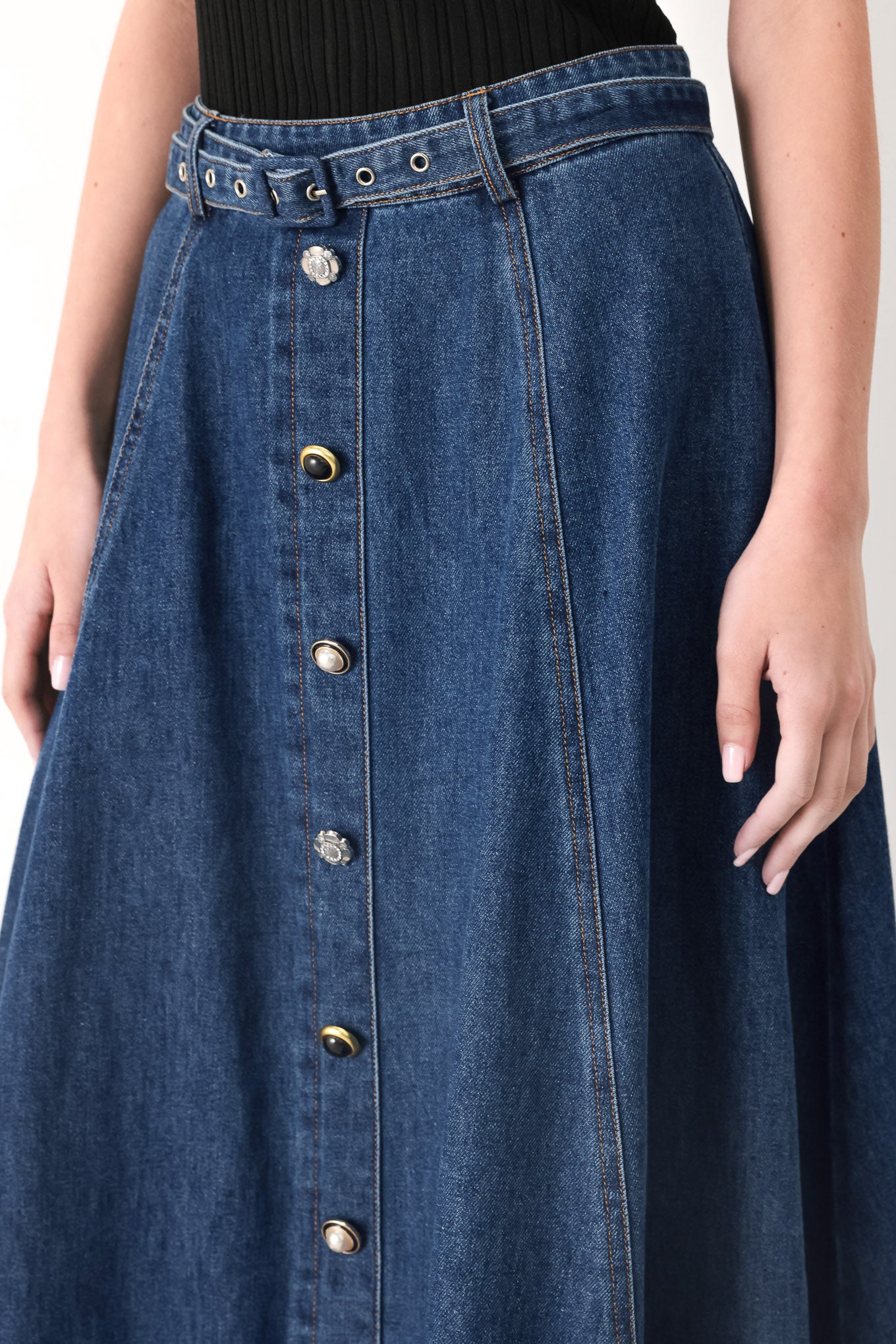 Woman wearing a blue denim circle midi skirt featuring self belt, button down detail and back zipper closure | FREEMARKET