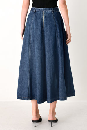 Woman wearing a blue denim circle midi skirt featuring self belt, button down detail and back zipper closure | FREEMARKET