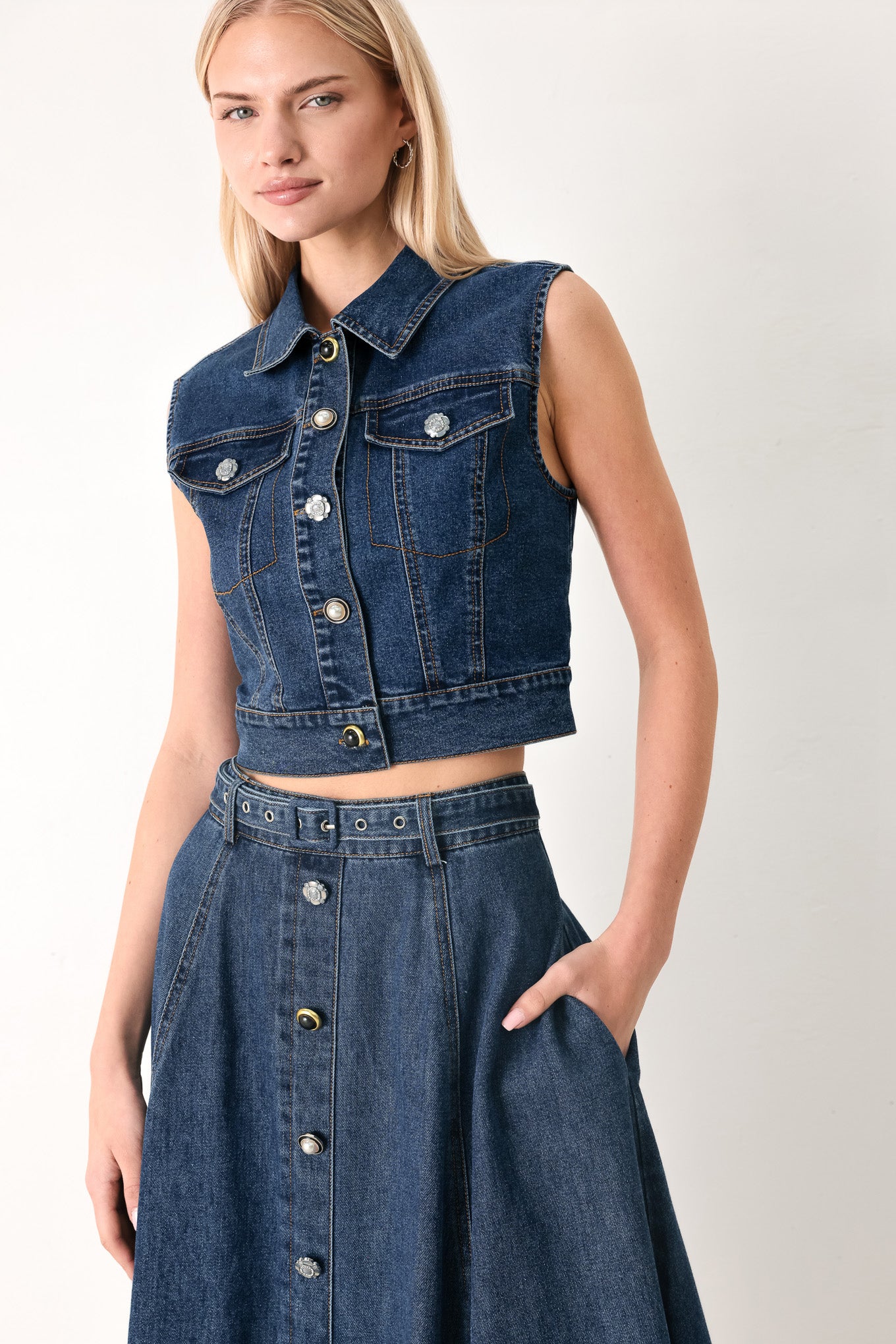 Woman wearing a blue denim circle midi skirt featuring self belt, button down detail and back zipper closure | FREEMARKET