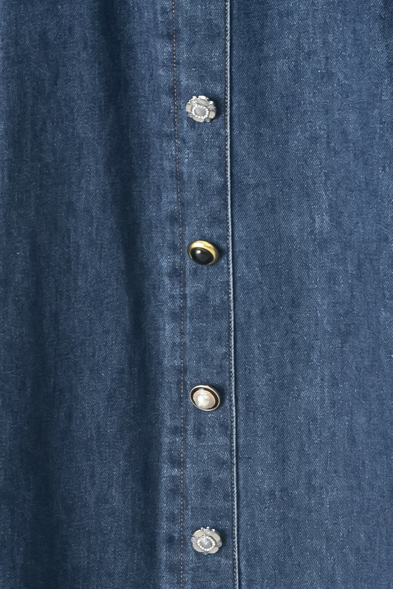 Close up of a blue denim circle midi skirt featuring self belt, button down detail and back zipper closure | FREEMARKET