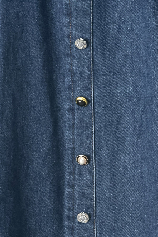 Close up of a blue denim circle midi skirt featuring self belt, button down detail and back zipper closure | FREEMARKET