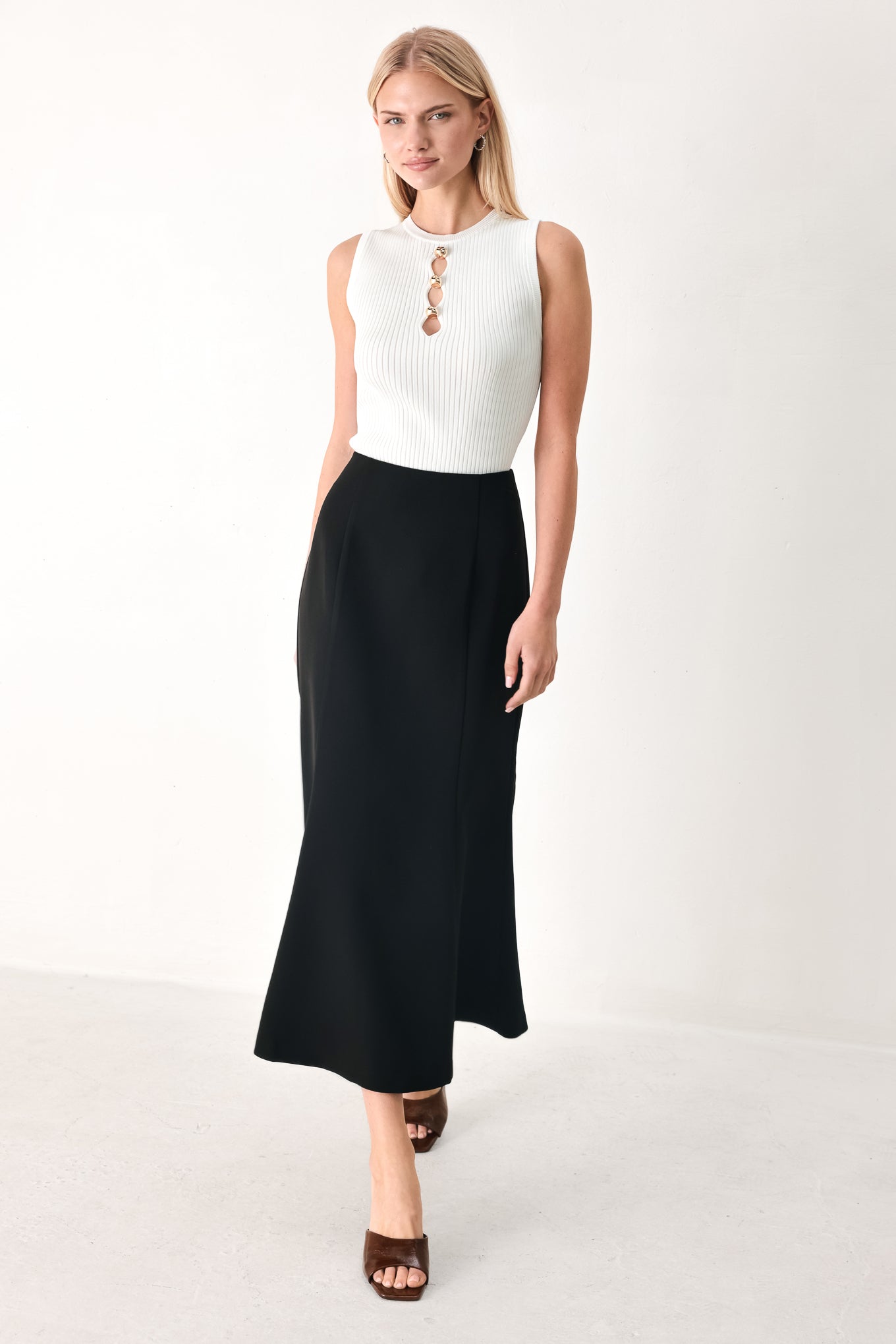 Woman wearing a black midi skirt with back zipper closure | FREEMARKET