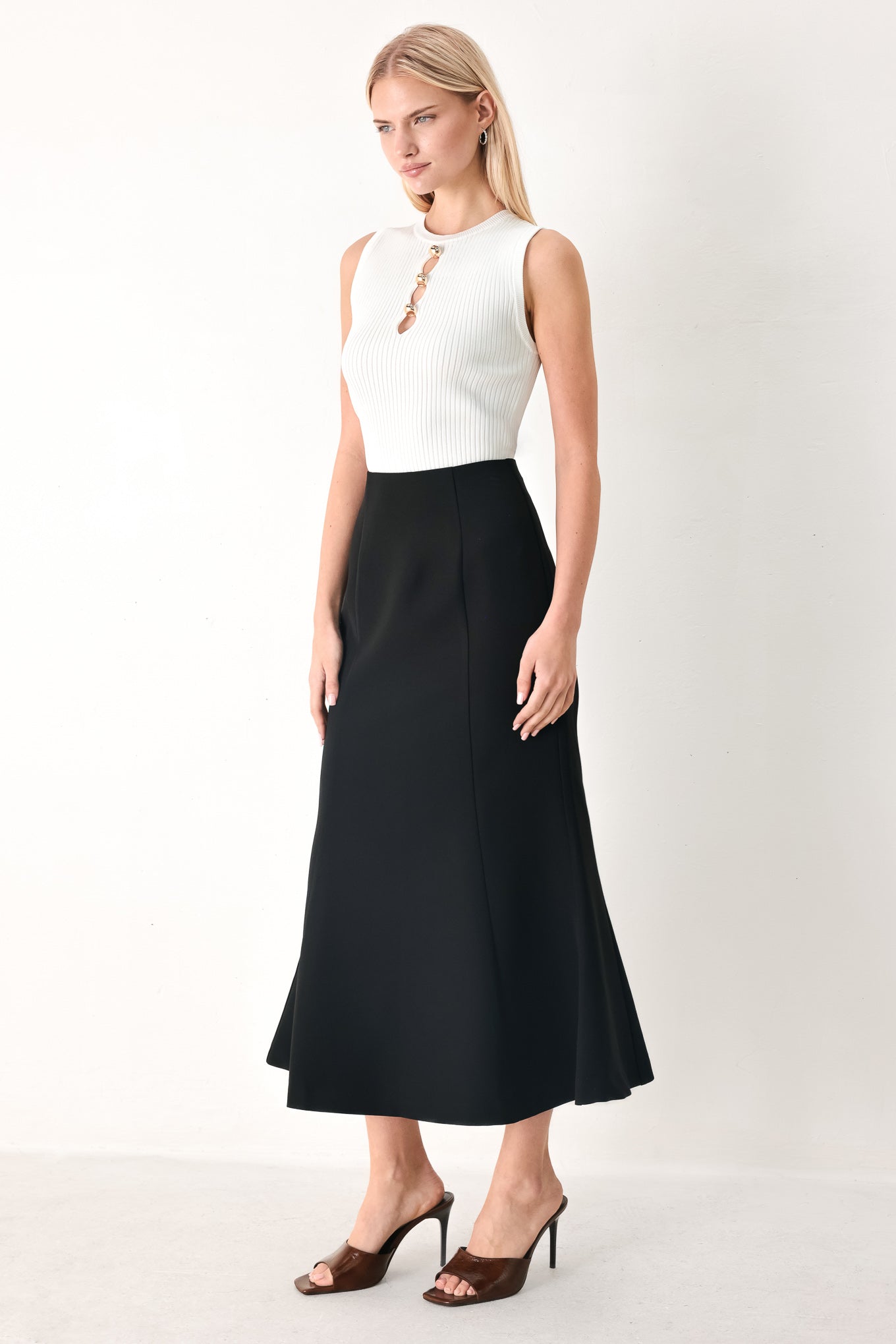 Woman wearing a black midi skirt with back zipper closure | FREEMARKET