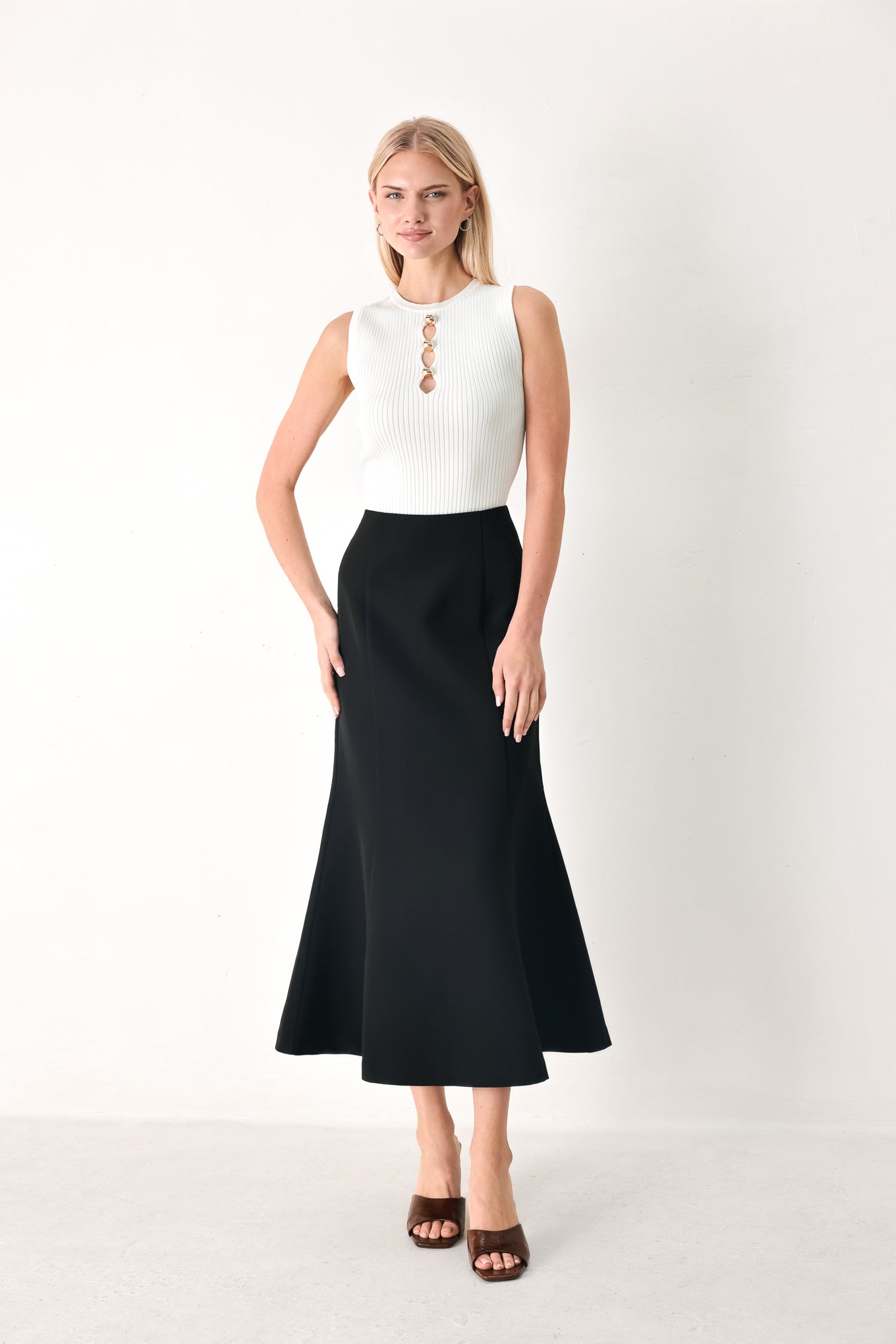 Woman wearing a black midi skirt with back zipper closure | FREEMARKET