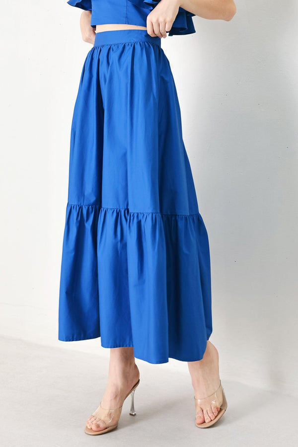 A solid woven midi skirt with ruffle hem and back zipper closure.