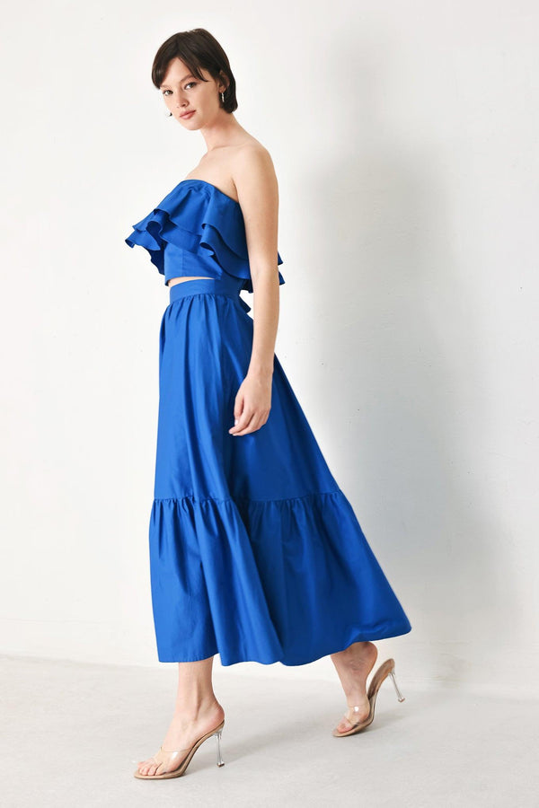 A solid woven midi skirt with ruffle hem and back zipper closure.