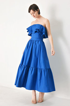 A solid woven midi skirt with ruffle hem and back zipper closure.