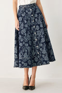 Woman wearing a denim woven jacquard full skirt with self belt and front button down | FREEMARKET