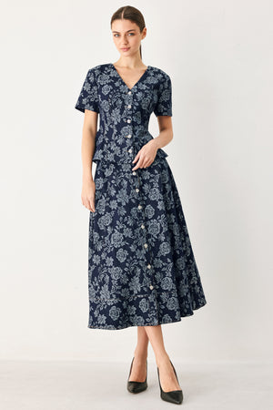 Woman wearing a denim woven jacquard full skirt with self belt and front button down | FREEMARKET