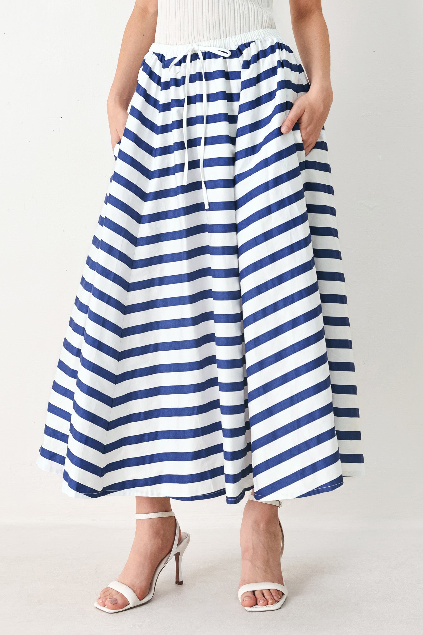 Woman wearing a blue and white striped printed woven full skirt with elastic waist and tie | FREEMARKET