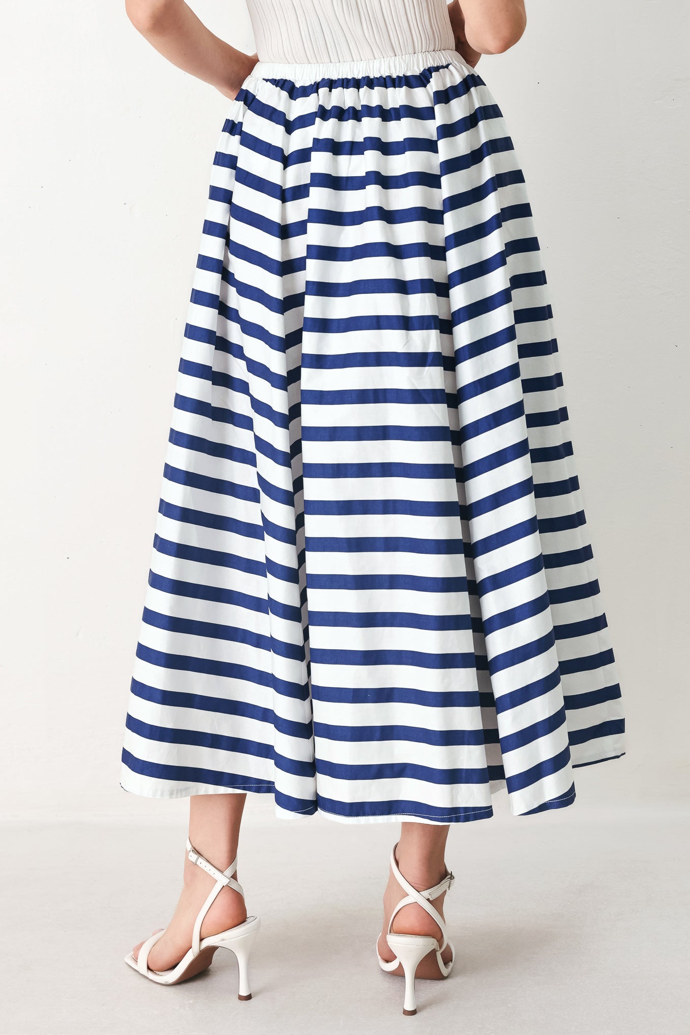 Woman wearing a blue and white striped printed woven full skirt with elastic waist and tie | FREEMARKET