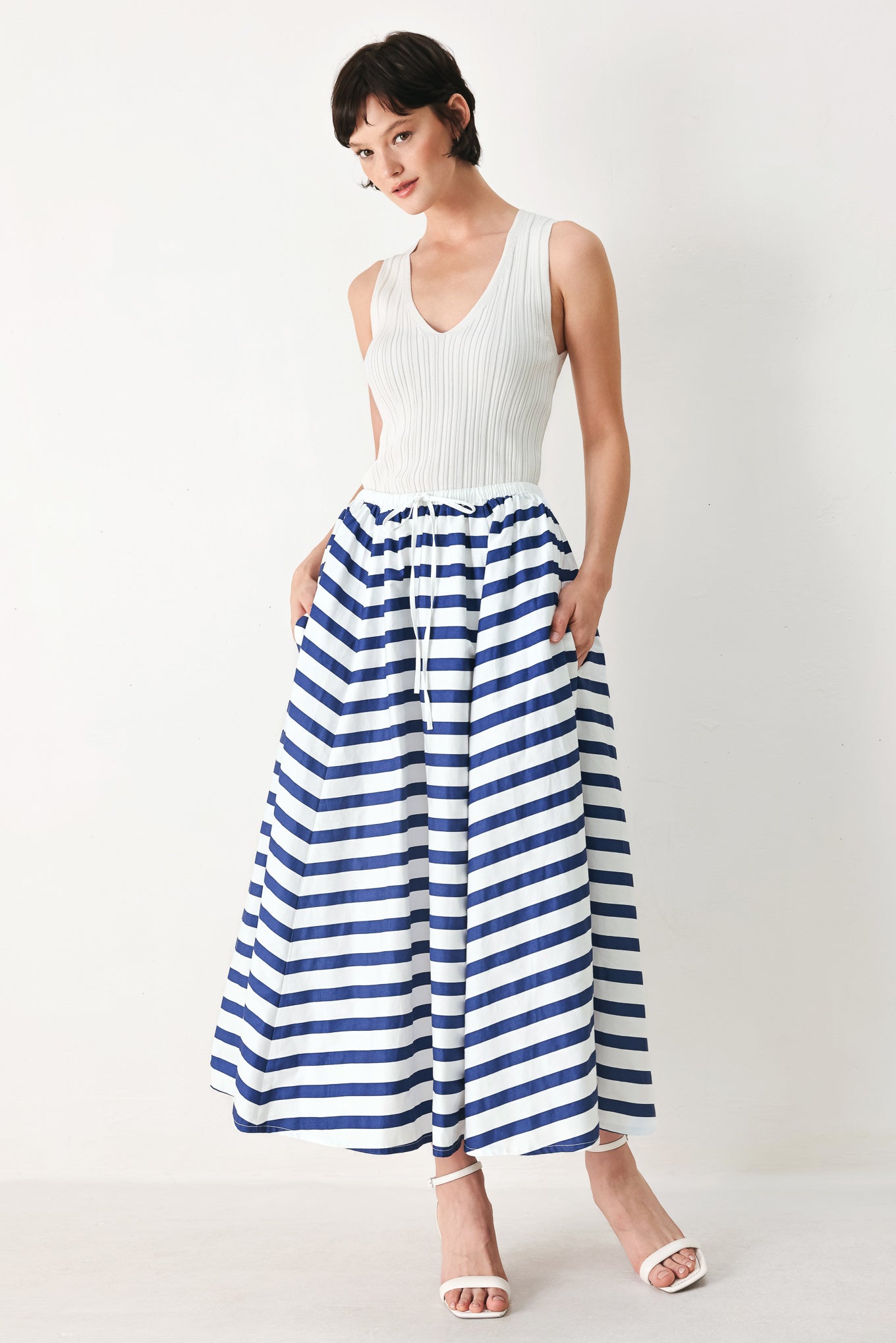 Woman wearing a blue and white striped printed woven full skirt with elastic waist and tie | FREEMARKET