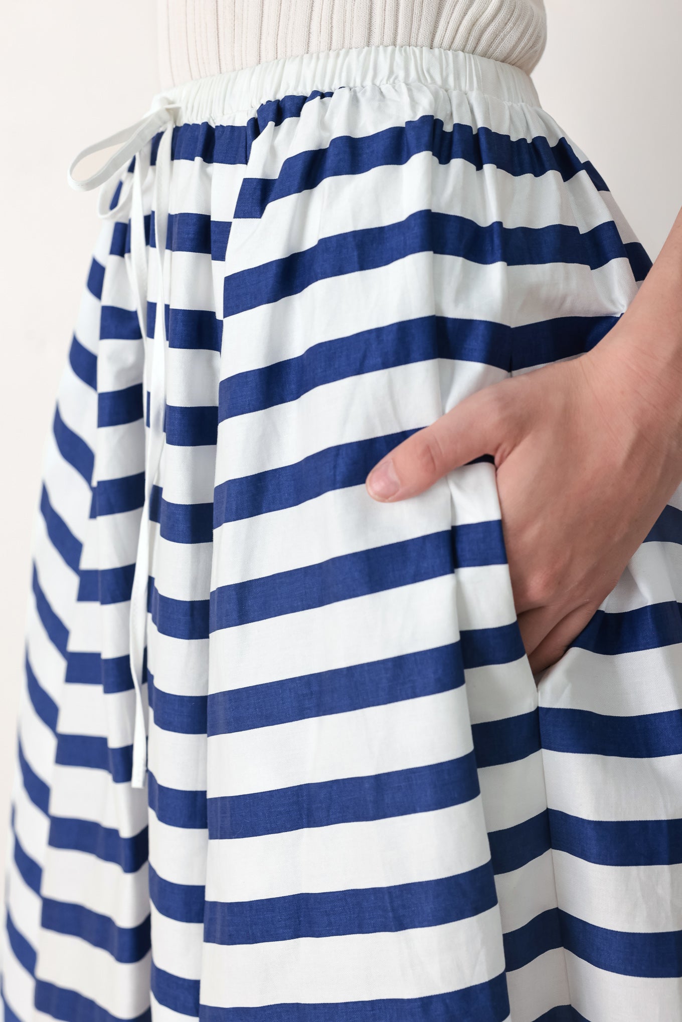 Woman wearing a blue and white striped printed woven full skirt with elastic waist and tie | FREEMARKET