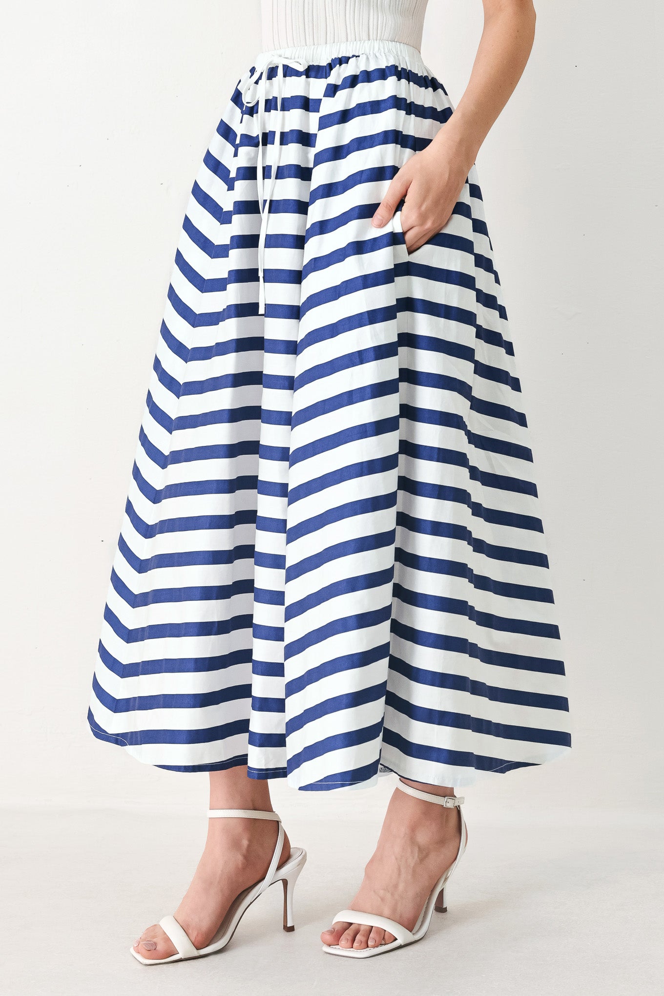 Woman wearing a blue and white striped printed woven full skirt with elastic waist and tie | FREEMARKET