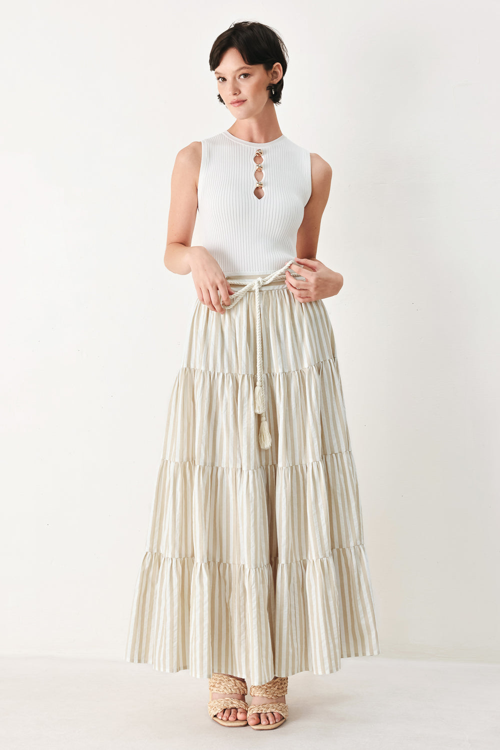 Woman wearing a long, tiered taupe and white striped maxi skirt with rope belt and elastic back waistband | FREEMARKET