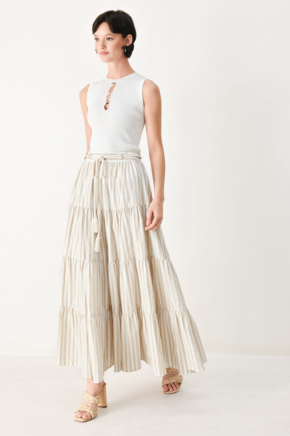 Woman wearing a long, tiered taupe and white striped maxi skirt with rope belt and elastic back waistband | FREEMARKET