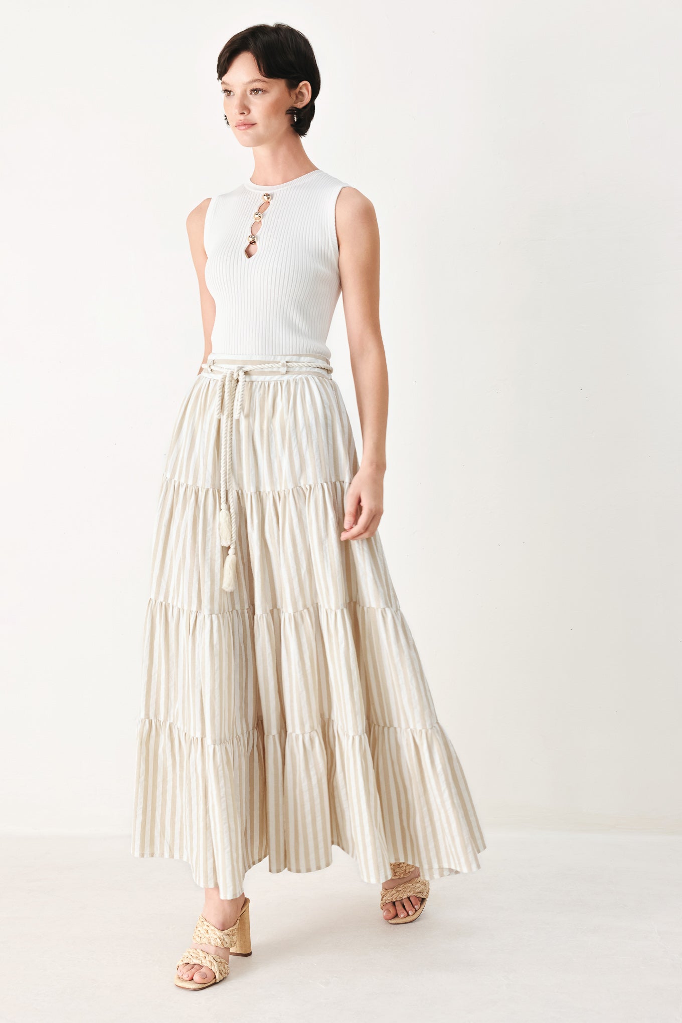 Woman wearing a long, tiered taupe and white striped maxi skirt with rope belt and elastic back waistband | FREEMARKET