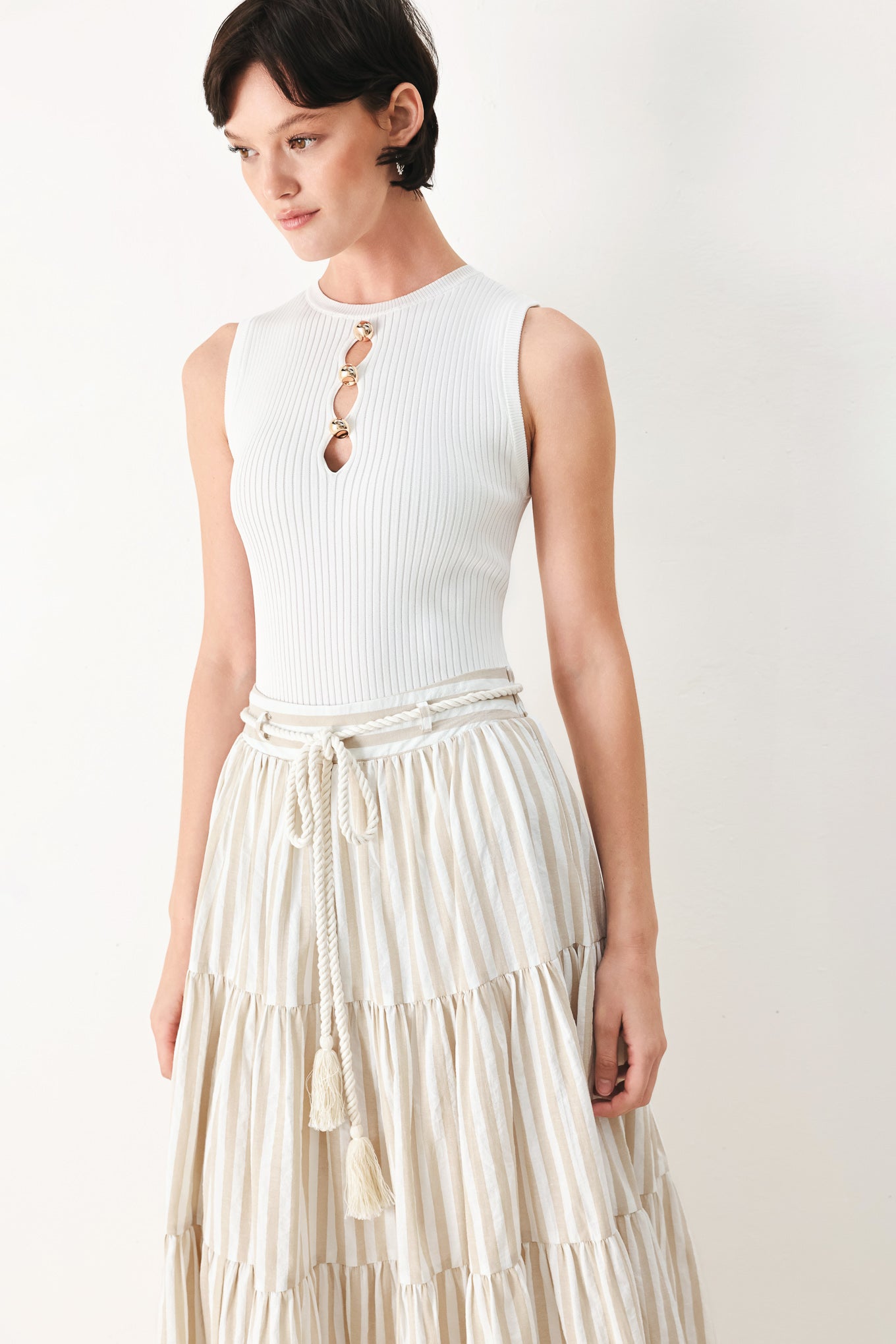 Woman wearing a long, tiered taupe and white striped maxi skirt with rope belt and elastic back waistband | FREEMARKET
