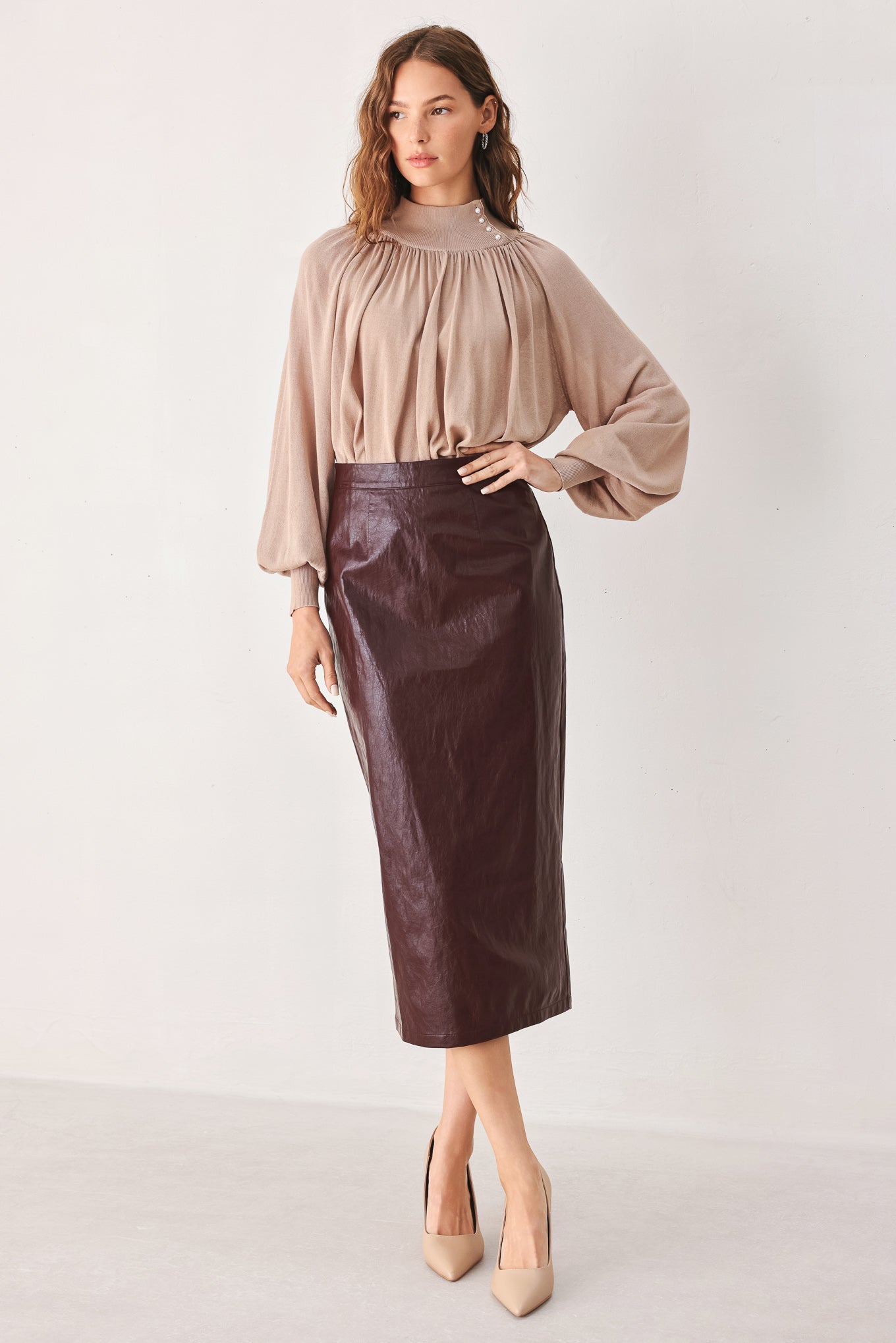 A woman wearing a burgundy faux-leather midi skirt | FREEMAKRET