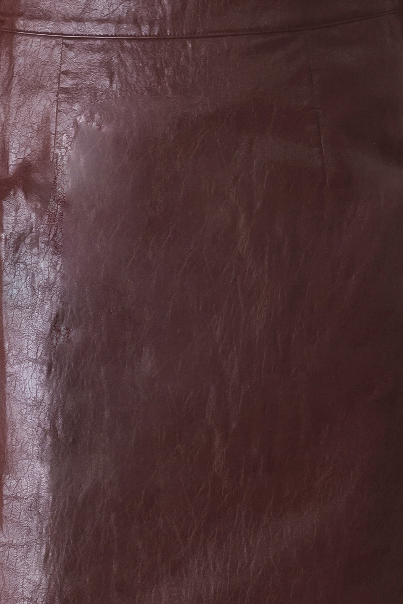 A woman wearing a burgundy faux-leather midi skirt | FREEMAKRET