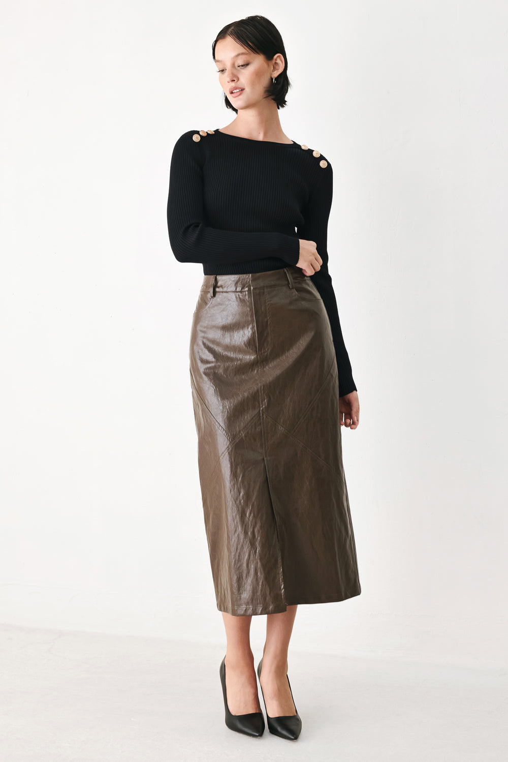 A model wearing a brown faux-leather midi skirt | FREEMARKET