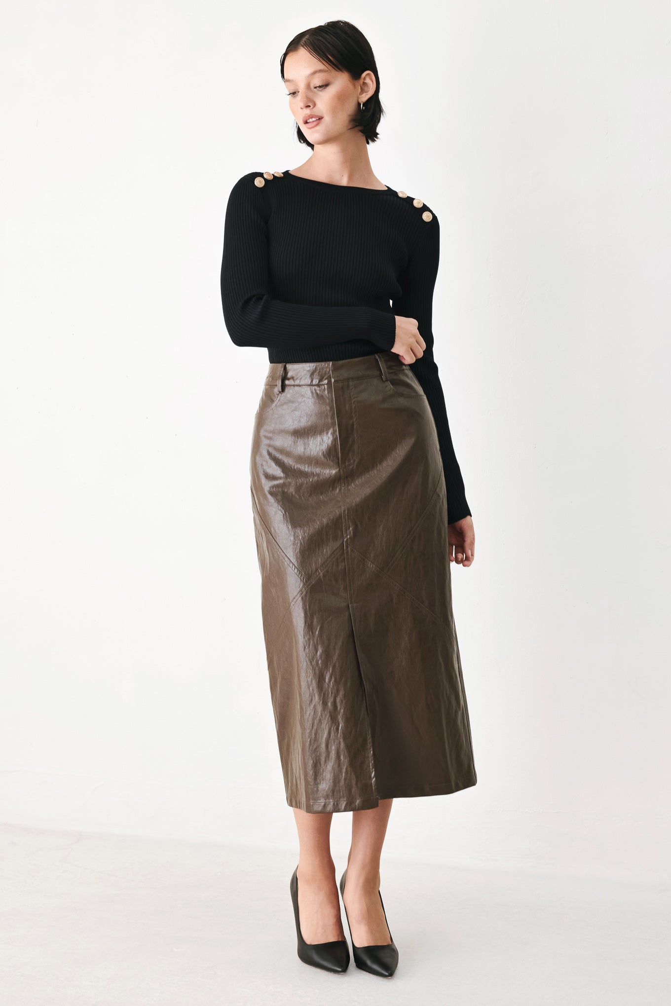 A model wearing a brown faux-leather midi skirt | FREEMARKET