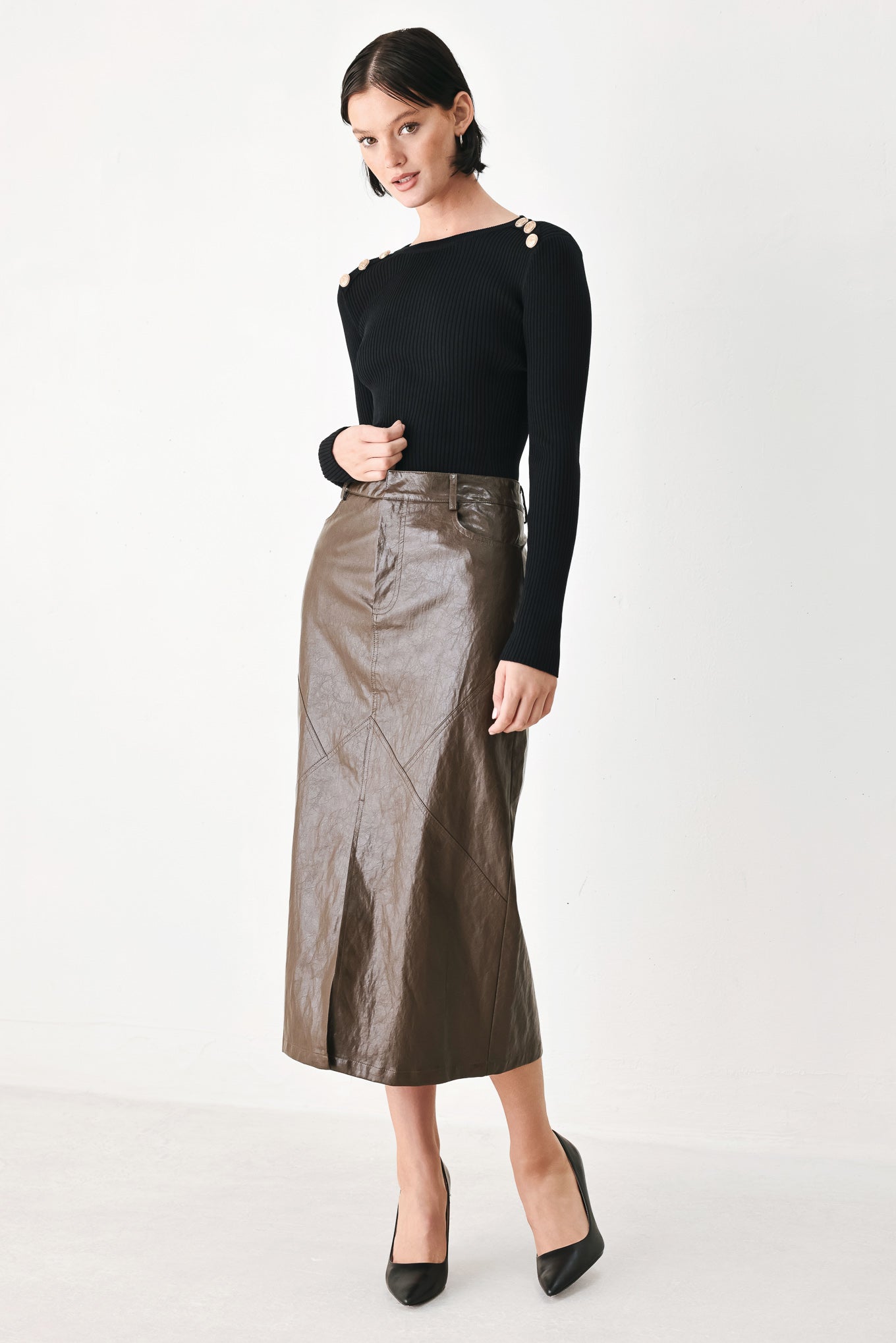 A model wearing a brown faux-leather midi skirt | FREEMARKET