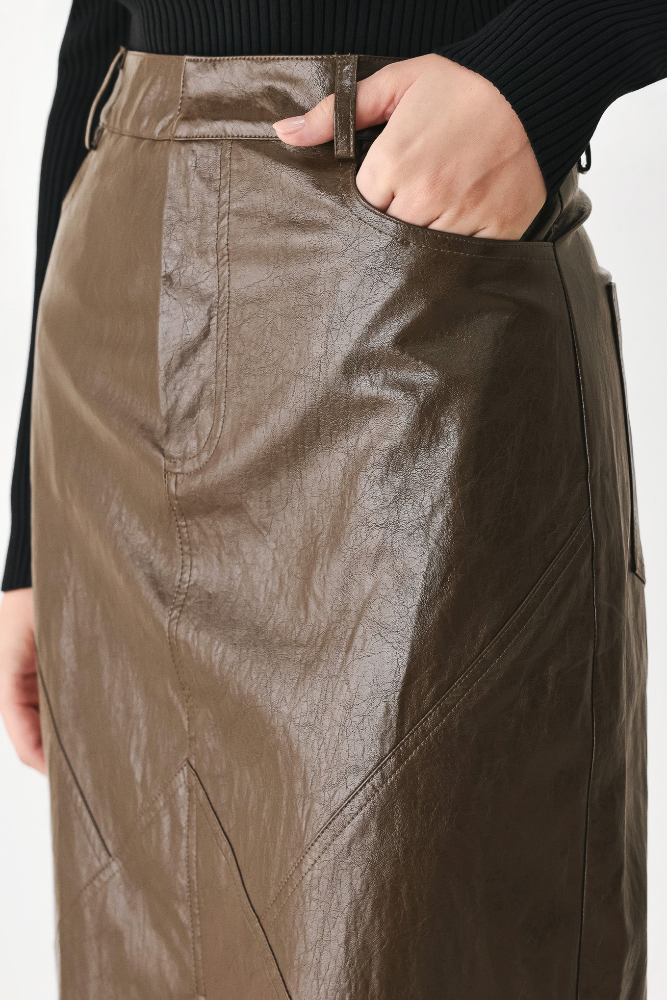 A model wearing a brown faux-leather midi skirt | FREEMARKET