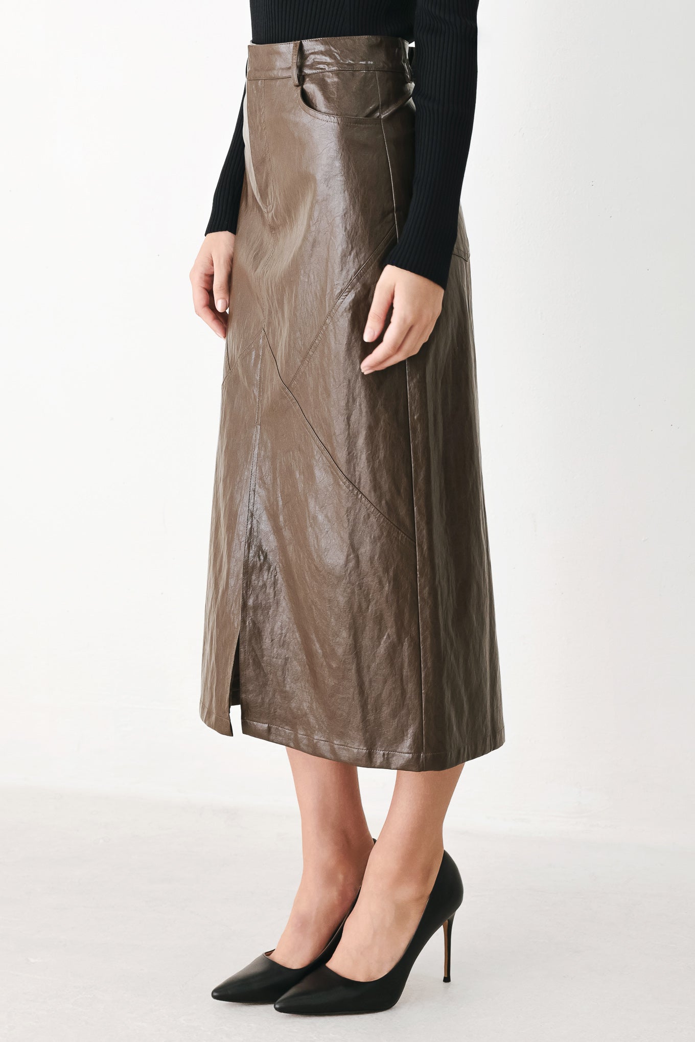 A model wearing a brown faux-leather midi skirt | FREEMARKET