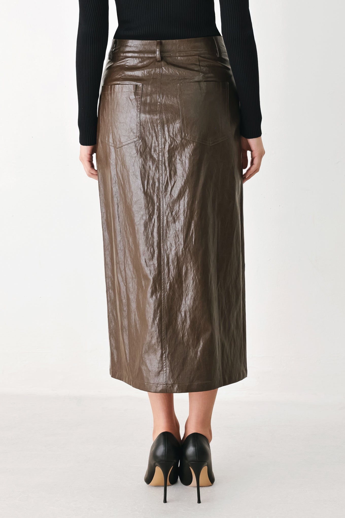 A model wearing a brown faux-leather midi skirt | FREEMARKET