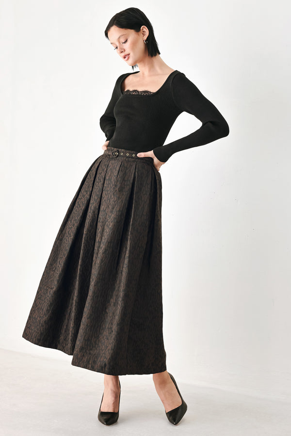 A high-waisted, pleated midi skirt in a dark brown and black jacquard leopard print pattern, styled with a matching belt  | FREEMARKET