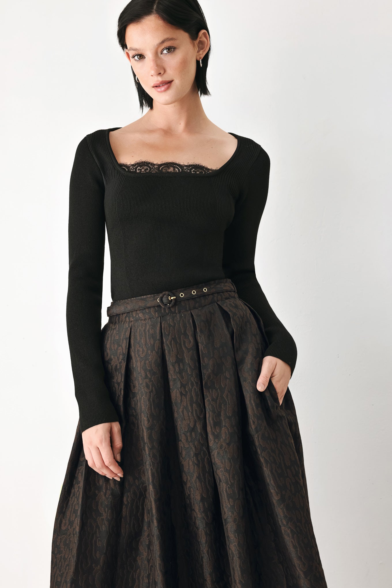 A high-waisted, pleated midi skirt in a dark brown and black jacquard leopard print pattern, styled with a matching belt  | FREEMARKET