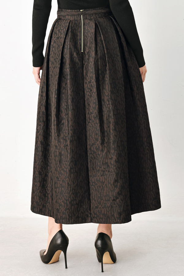 A high-waisted, pleated midi skirt in a dark brown and black jacquard leopard print pattern, styled with a matching belt  | FREEMARKET