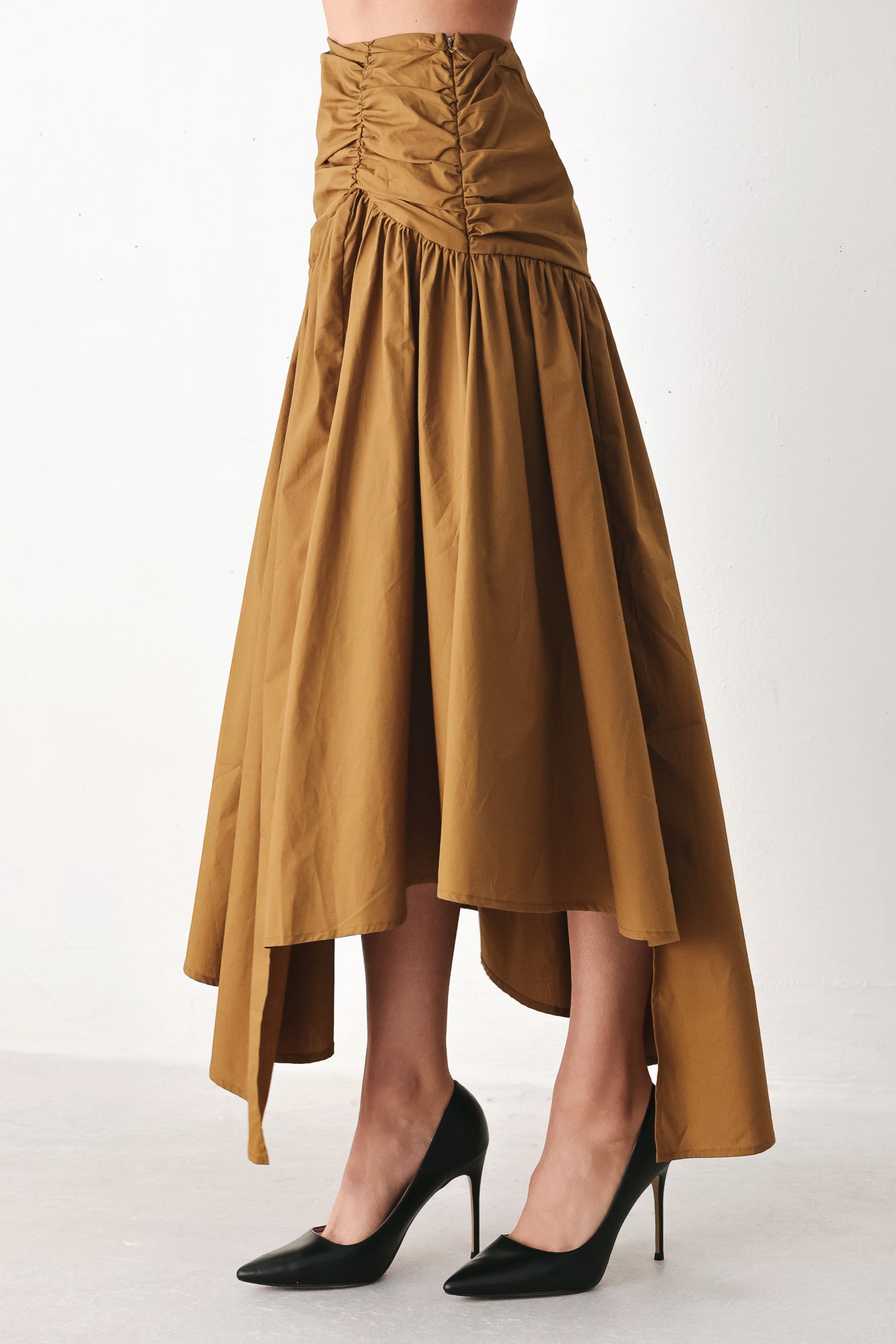 A model wearing a high-waisted, ruched A-line midi skirt in a warm caramel brown color | FREEMARKET