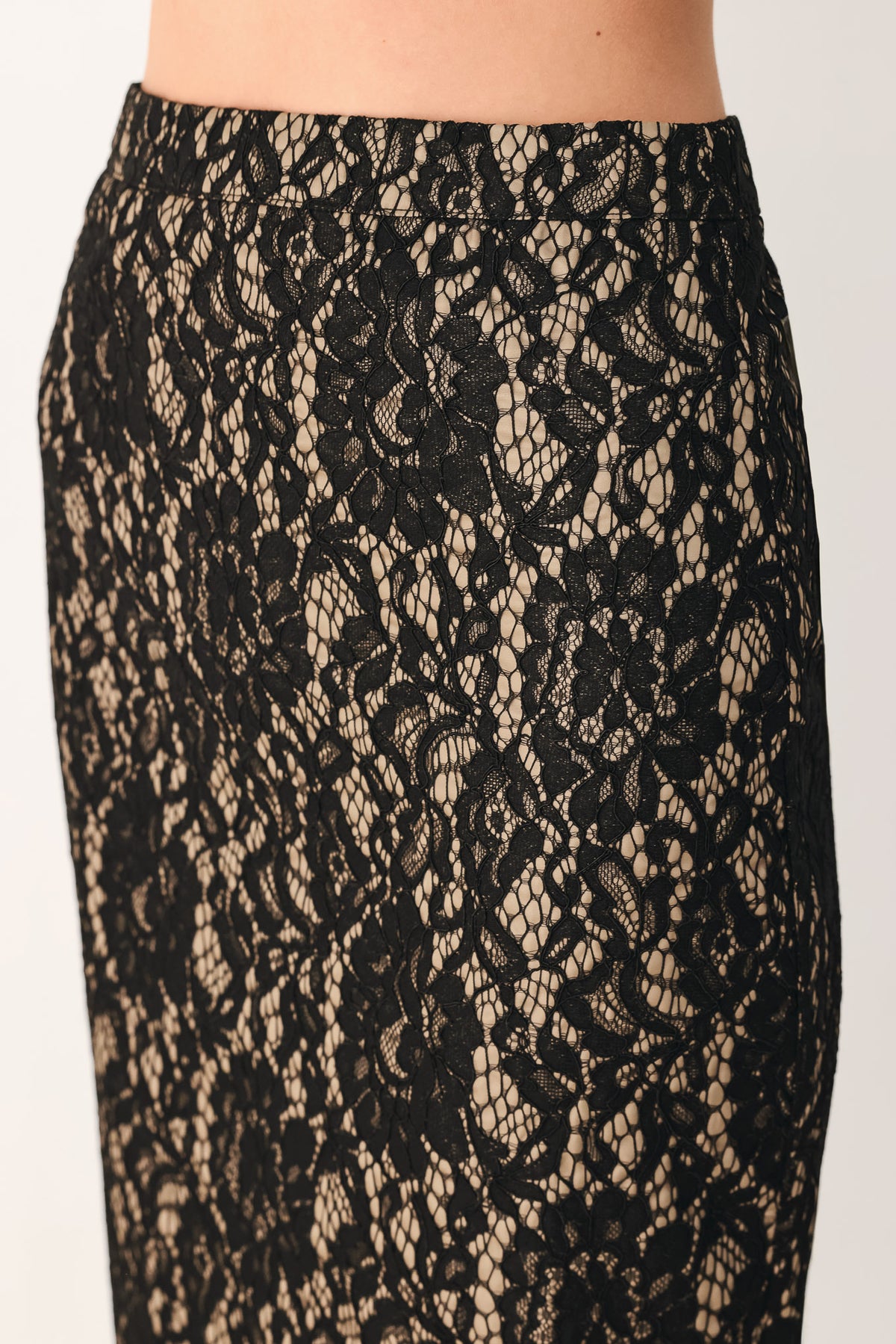 A model wearing a black lace midi skirt | Flying Tomato