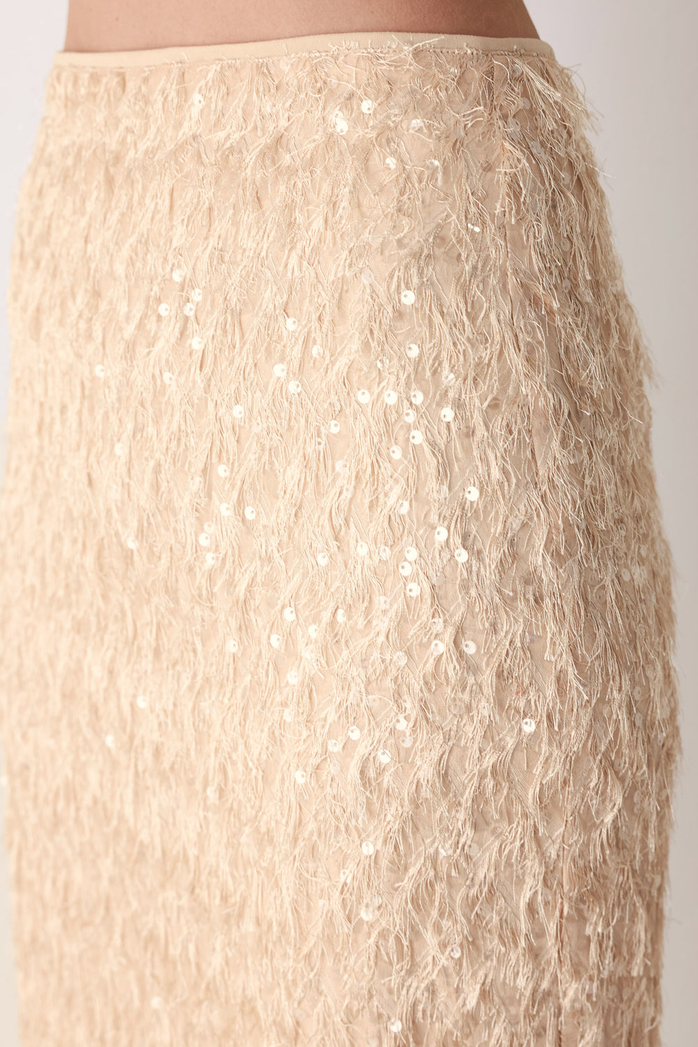 Woman wearing a high waisted midi skirt with sequins and fine faux fur/feathers | FREEMARKET