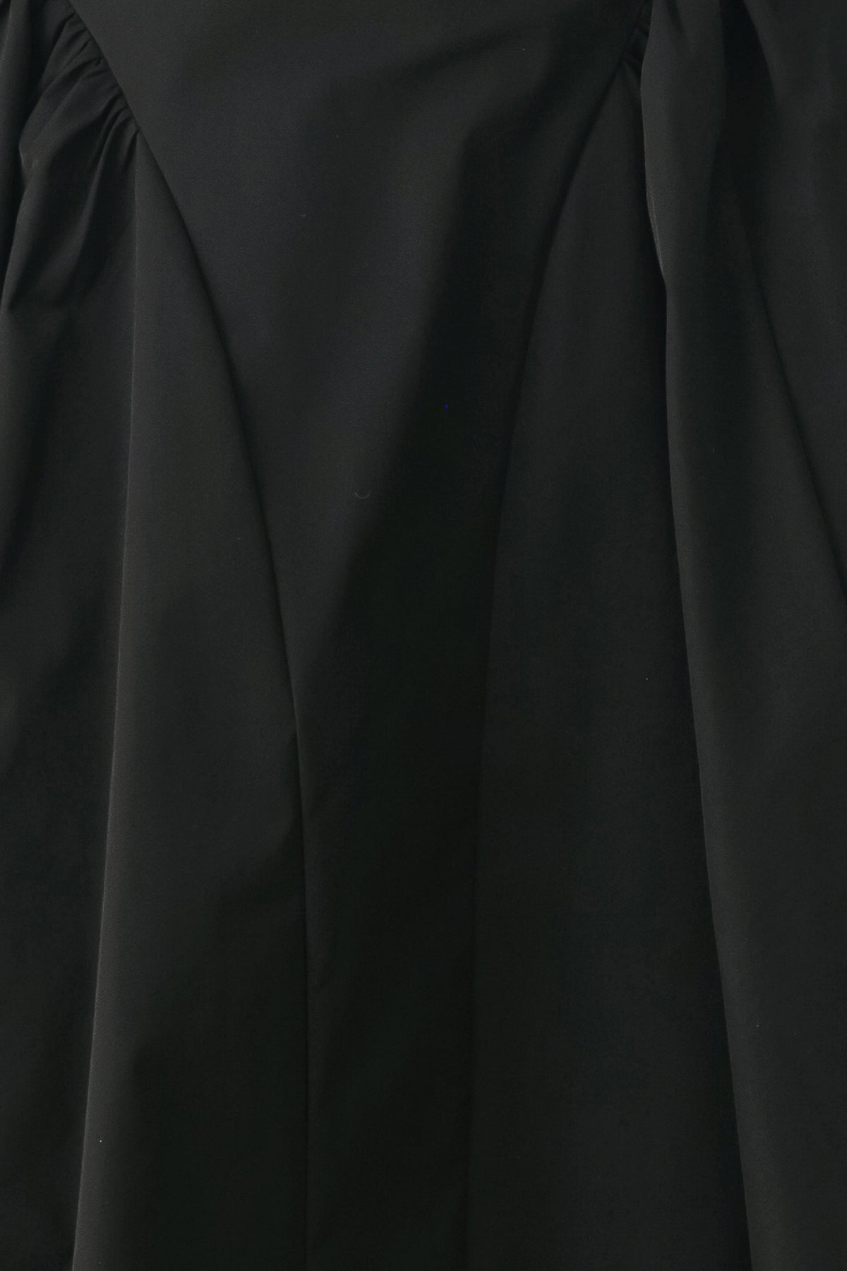 Woman wearing a high waisted black midi skirt with side shirring along the hips | FREEMARKET