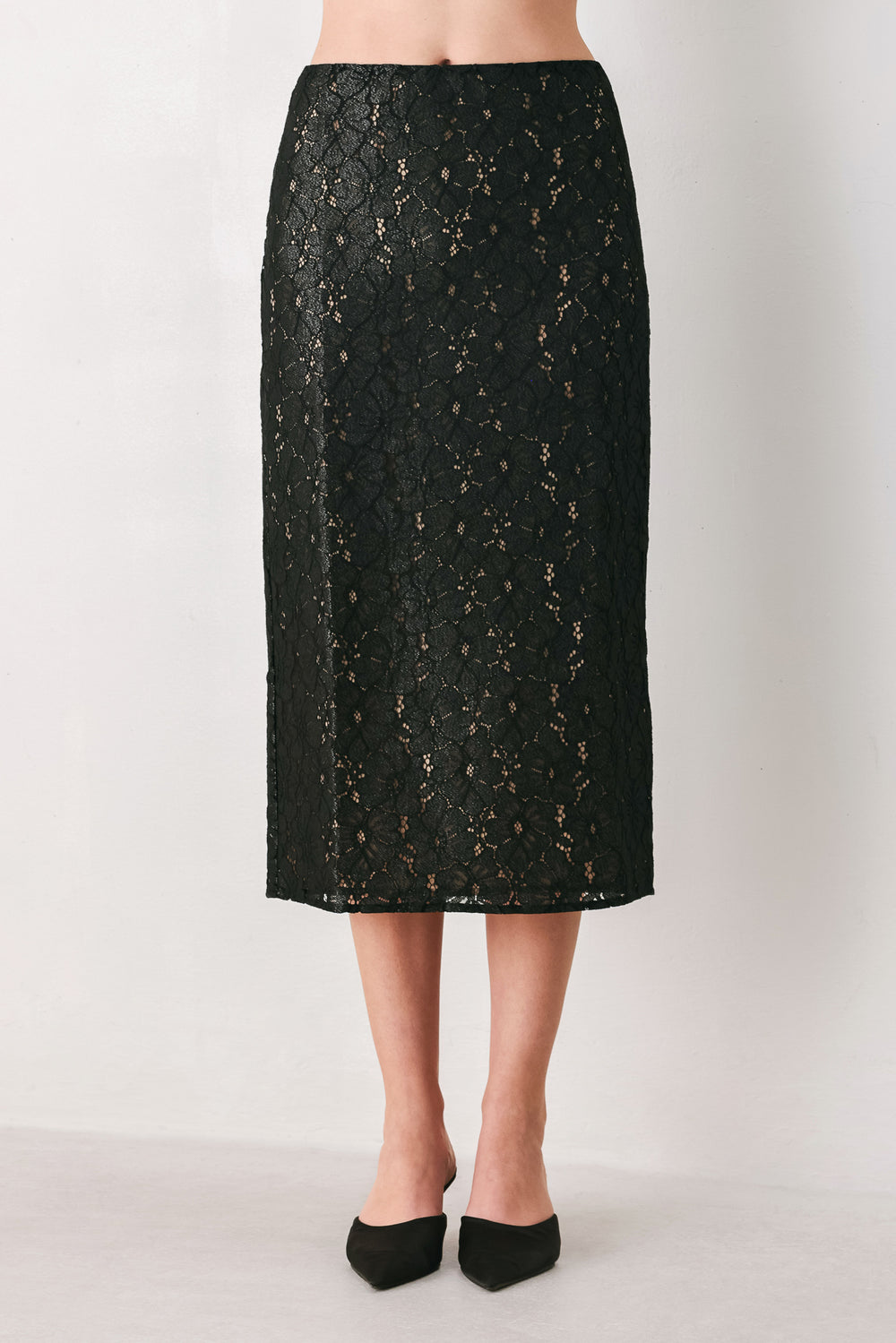 Woman wearing a black lace high waisted midi skirt with a nude base | FREEMARKET