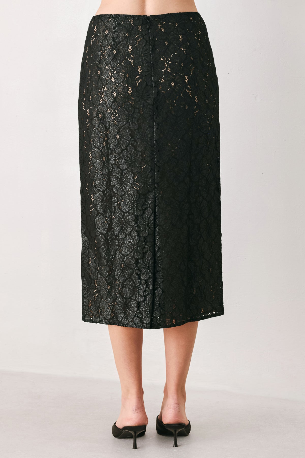 Woman wearing a black lace high waisted midi skirt with a nude base | FREEMARKET