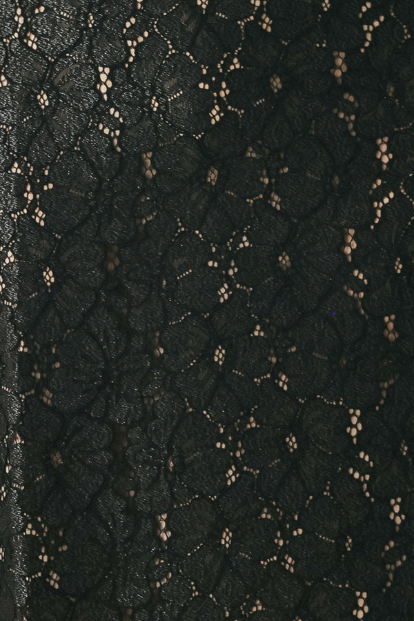 Woman wearing a black lace high waisted midi skirt with a nude base | FREEMARKET