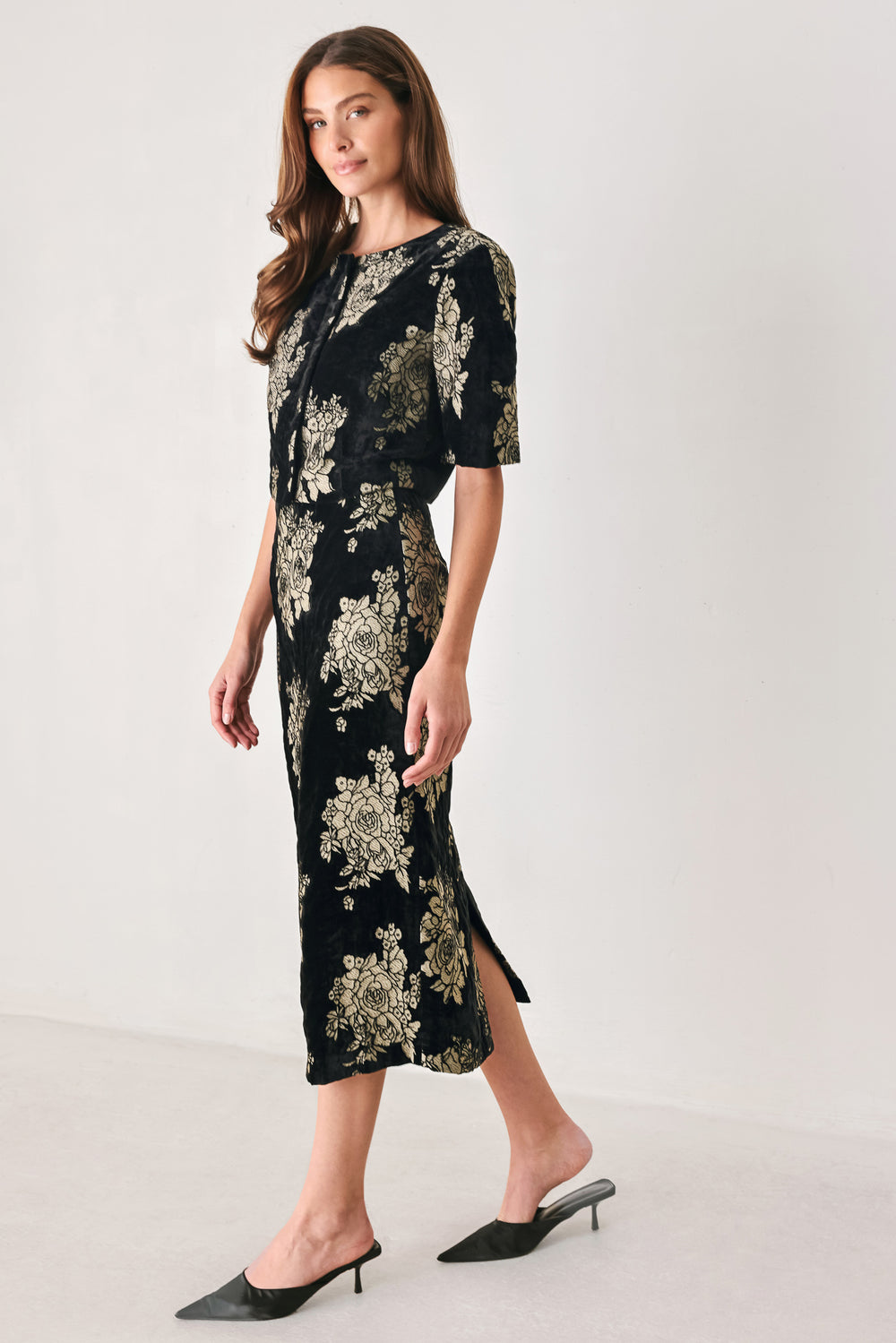 Woman wearing a back high waisted midi skirt with gold jacquard flowers | FREEMARKET