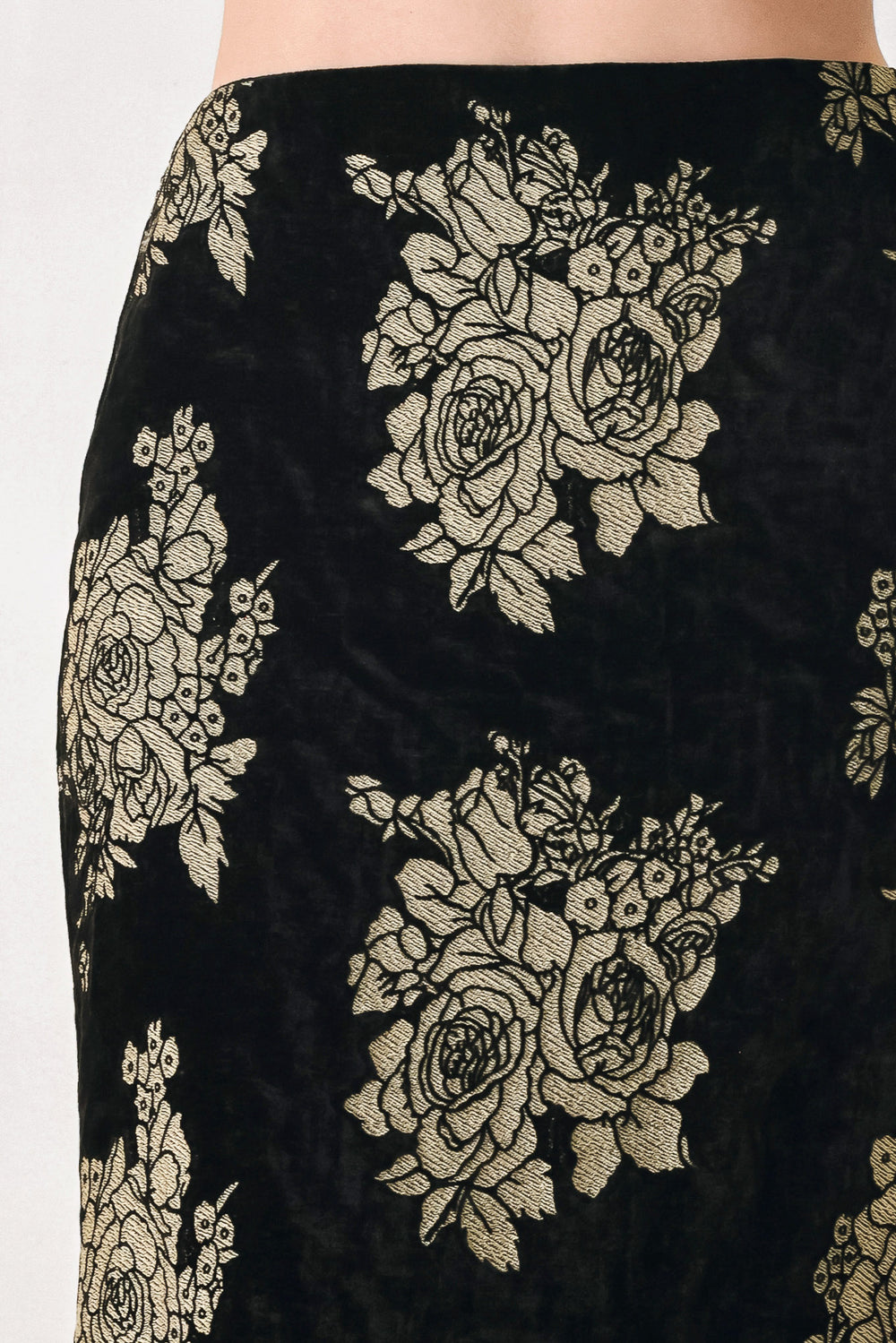 Woman wearing a back high waisted midi skirt with gold jacquard flowers | FREEMARKET