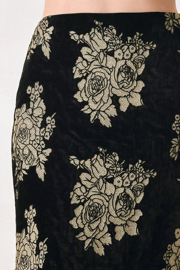 Woman wearing a back high waisted midi skirt with gold jacquard flowers | FREEMARKET