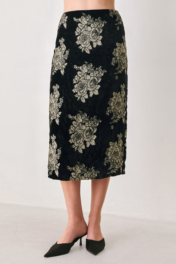 Woman wearing a back high waisted midi skirt with gold jacquard flowers | FREEMARKET