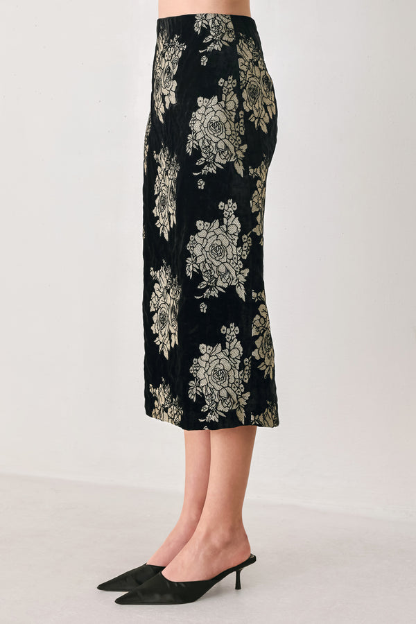 Woman wearing a back high waisted midi skirt with gold jacquard flowers | FREEMARKET