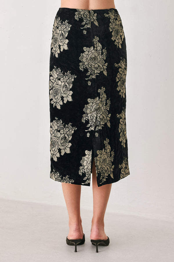 Woman wearing a back high waisted midi skirt with gold jacquard flowers | FREEMARKET