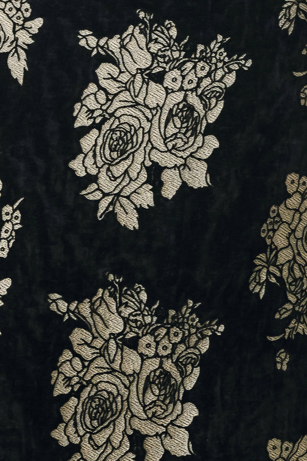 Woman wearing a back high waisted midi skirt with gold jacquard flowers | FREEMARKET