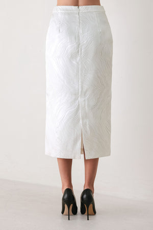 A white midi skirt with a subtle textured, wavy jacquard pattern, shown on a model | FREEMARKET