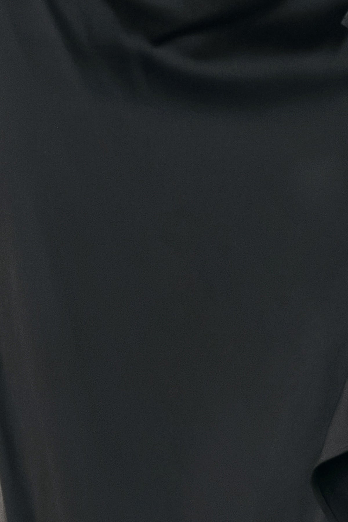 A black midi skirt with a draped, gathered waist and cascading ruffle detail along the side, shown on a model | FREEMARKET